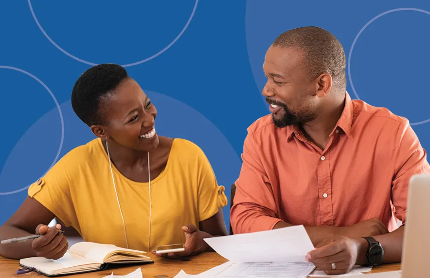 Smiling couple reviewing Louisiana workers' compensation settlement paperwork